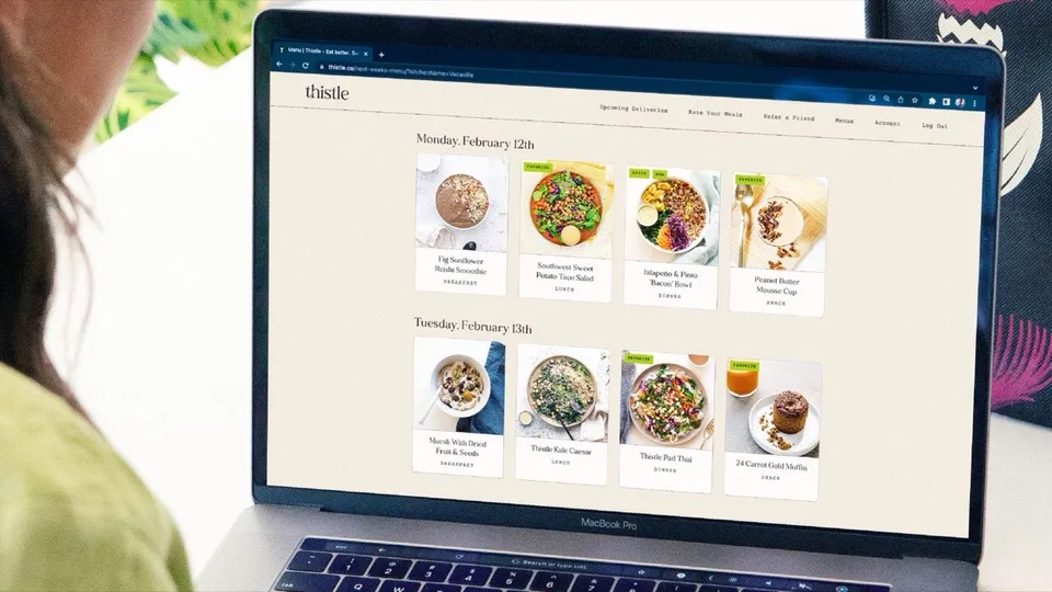 A Thistle customer choosing the week's breakfasts, lunches and dinners on Thistle's menu page on a laptop